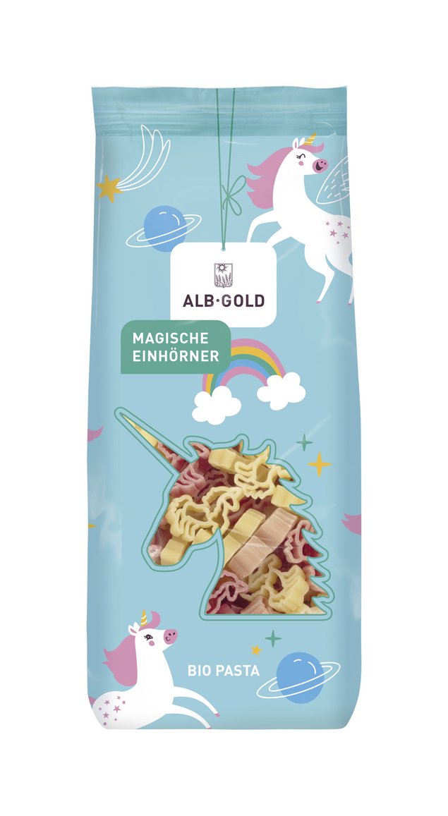 Alb-Gold Bio Pasta in Einhornform auf hellblauem Hintergrund mit Einhorn-Illustrationen und Regenbogen